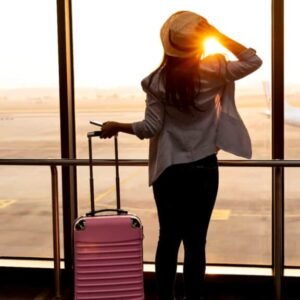 Woman-at-airport-looking-out-windows. Woman-at-airport-looking-out-windows.-Image-credit-Nok-Lek-Travel-Lifestyle